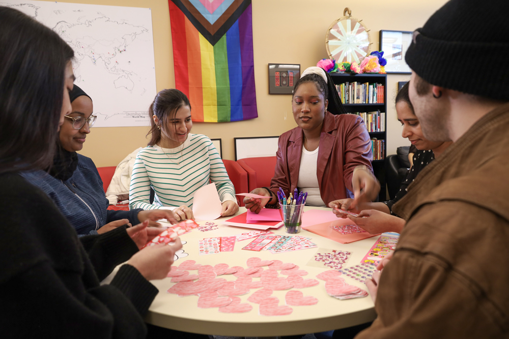 Students sitting around circular table making crafts in the Center for Inclusion, Advocacy, and Community